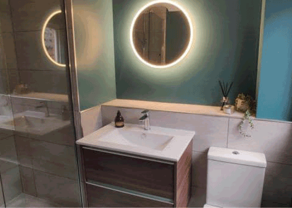 Splash Kitchens & Bathrooms - Bathroom featuring a Round LED Mirror, Vanity Unit and Toilet