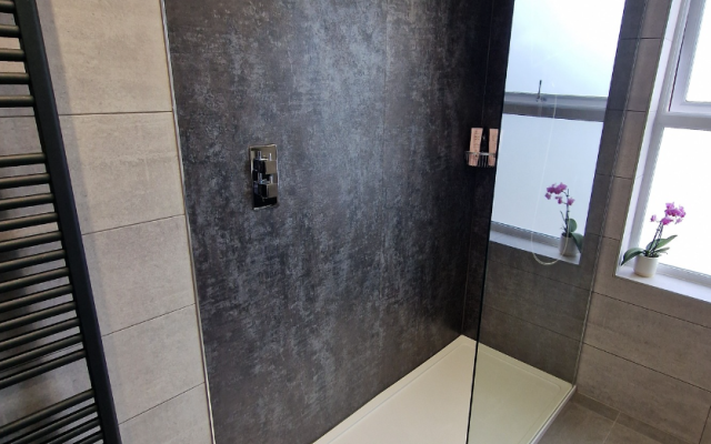 Walkin shower with grey slate wall panel