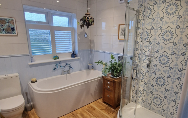 Family bathroom with shower and patterned tiles