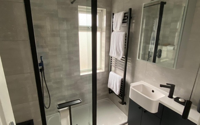 Walk-in shower with black trim