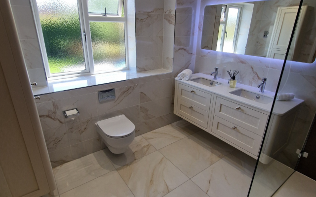 Marble family bathroom with twin basins